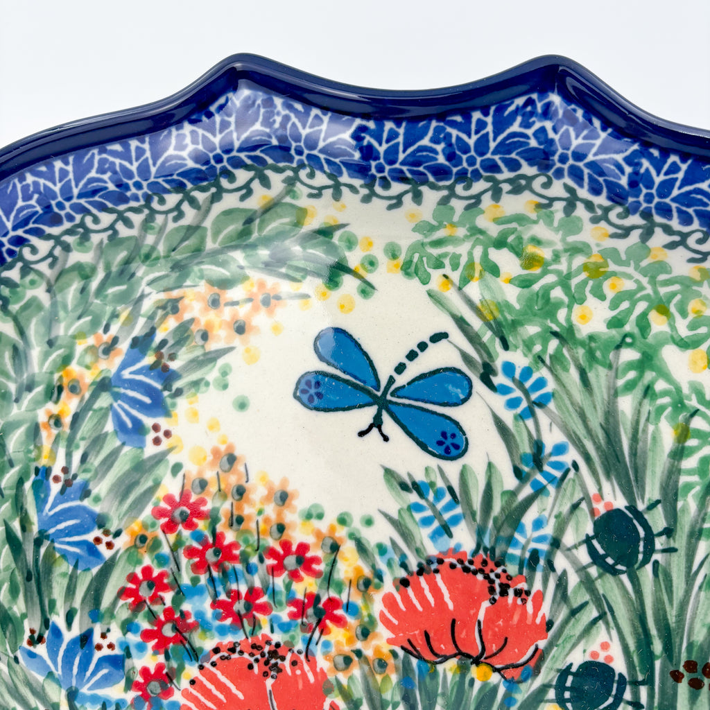 UNIKAT Dragonfly Bounty 8 point platter, close-up view of blue dragonfly and scalloped rim with garden florals