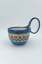 Maraschino loop-handle bowl, straight-on front view with plant in background