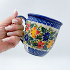 Fall Colors Viking mug held in hand, front view showing autumn floral pattern