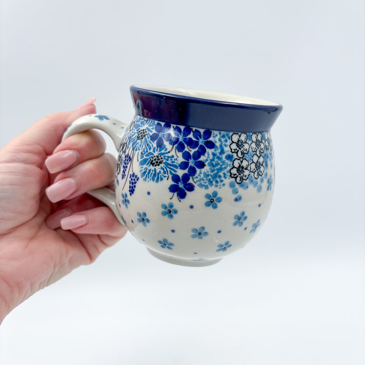 Morning Glory bubble mug held in hand, front view