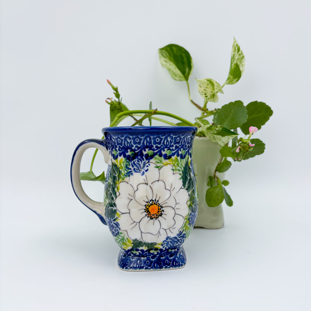 Wild Rose tulip mug, front view with plants in background