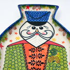 UNIKAT Green Nutcracker figural platter, close-up of face with white mustache and blue hat