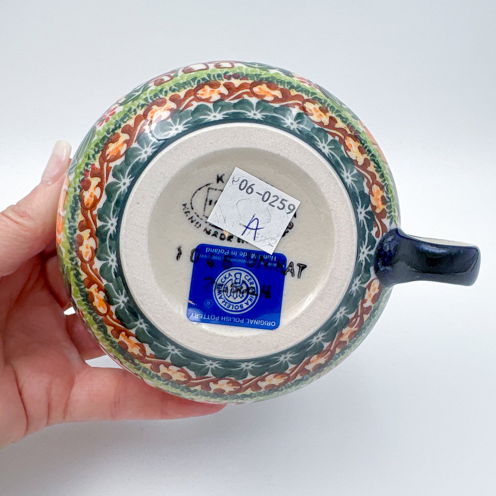 Bottom of Hedgehog and Acorns latte mug, held in hand
