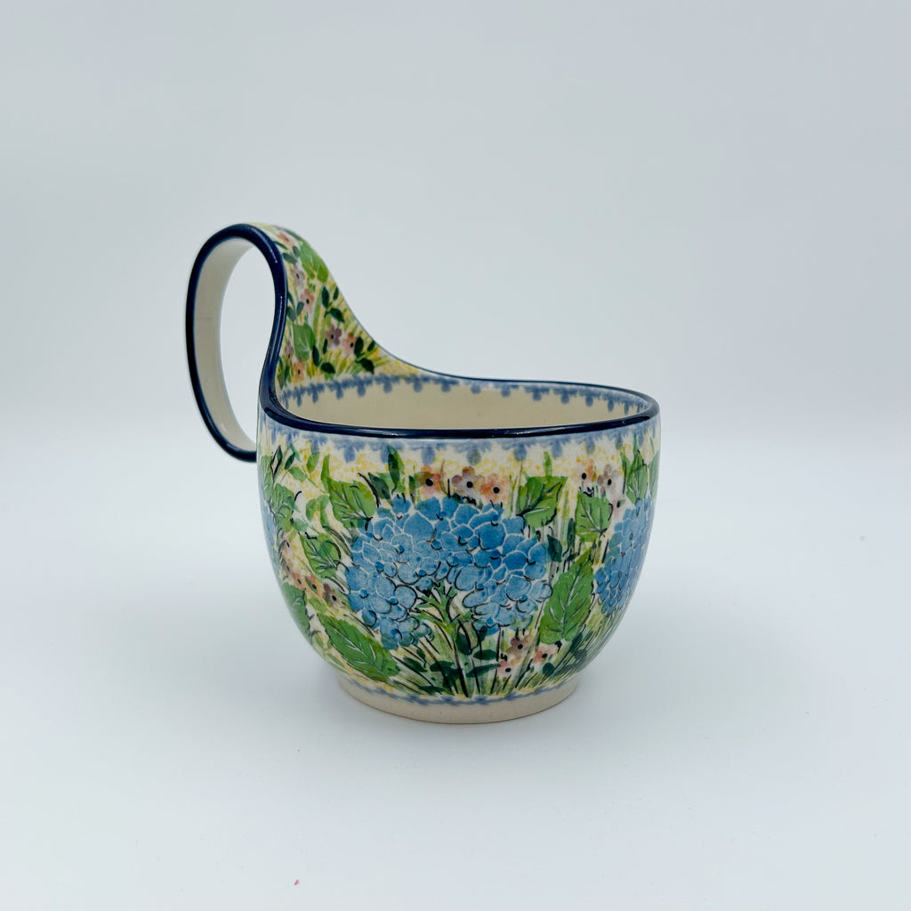 Polish pottery 16oz bowl with loop handle in the UNIKAT Blue Hydrangea pattern. This Polish Pottery bowl is made by talented artisans from Poland. 
6.26" x 4.49" x 5.51"
Ceramika Artystyczna Company