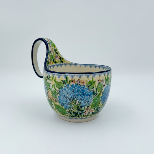 Polish pottery 16oz bowl with loop handle in the UNIKAT Blue Hydrangea pattern. This Polish Pottery bowl is made by talented artisans from Poland. 
6.26" x 4.49" x 5.51"
Ceramika Artystyczna Company