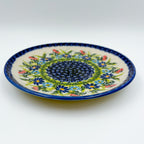 UNIKAT Meadow Breeze plate, front view showing navy mosaic center and blue wildflower ring