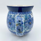 Close-up front view of Deep Winter bubble mug showing blue-on-blue pansy pattern