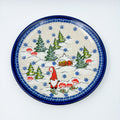 UNIKAT Gnome Village plate, top-down view showing gnome, snowy cabin, and pine trees scene