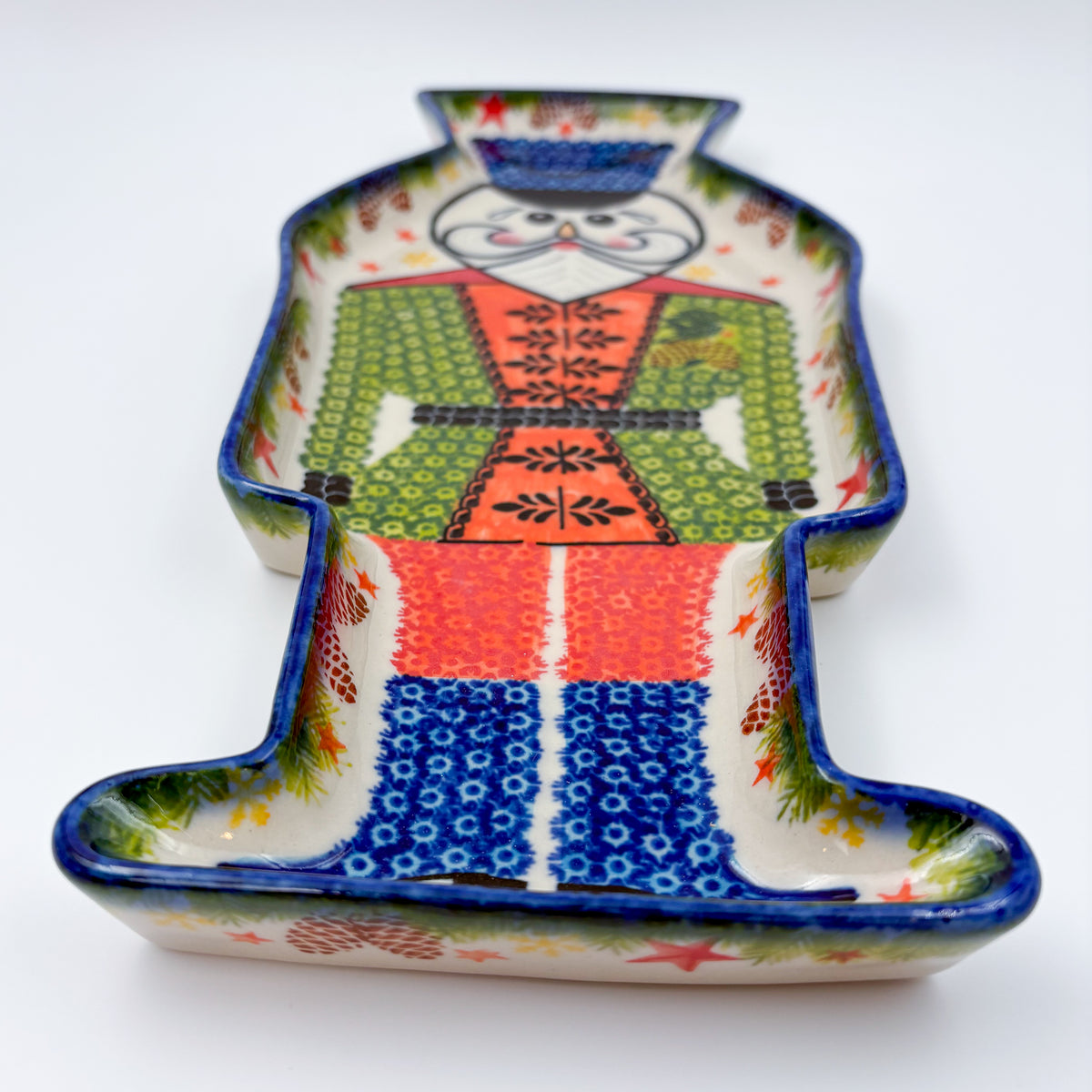 UNIKAT Green Nutcracker figural platter, top-down view of full nutcracker-shaped platter with painted uniform