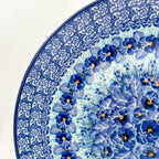 UNIKAT Deep Winter plate, close-up rim detail showing rose border and blue pansy ring
