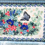 Mariposa rectangular platter, close-up top-down view of black butterfly and blue and pink floral bouquet