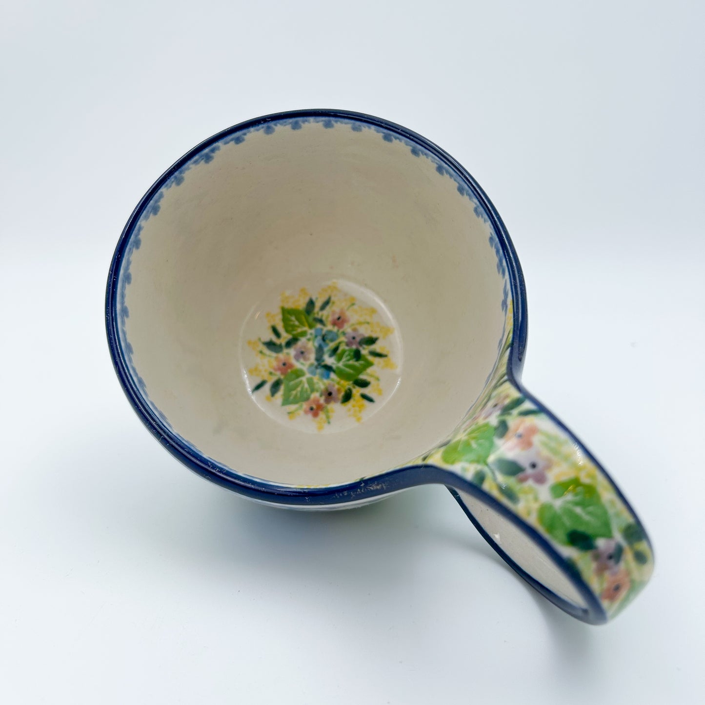 Polish pottery 16oz bowl with loop handle in the UNIKAT Blue Hydrangea pattern. This Polish Pottery bowl is made by talented artisans from Poland. 
6.26" x 4.49" x 5.51"
Ceramika Artystyczna Company