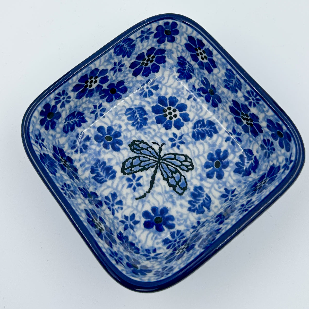Misty Dragonfly square bowl, top-down view showing dragonfly centered in blue floral pattern