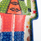 UNIKAT Green Nutcracker figural platter, close-up detail of patterned uniform coat and legs
