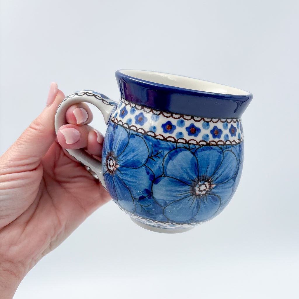 Cobalt Poppies bubble mug held in hand, front view