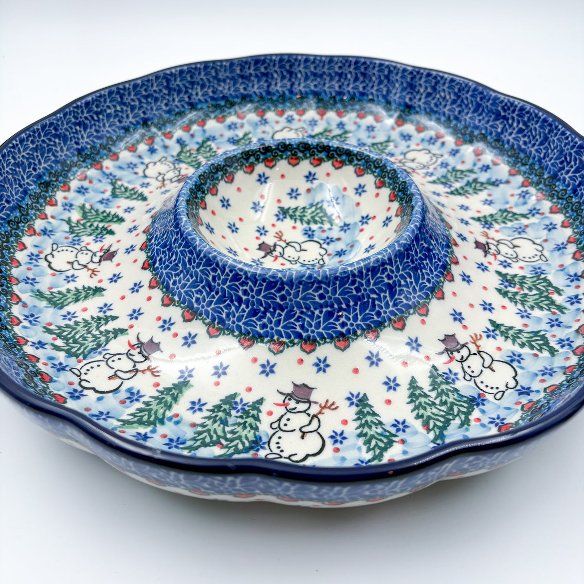 Dancing Snowman chip and dip platter, angled front view showing scalloped rim, center dip bowl, and snowmen with pine trees