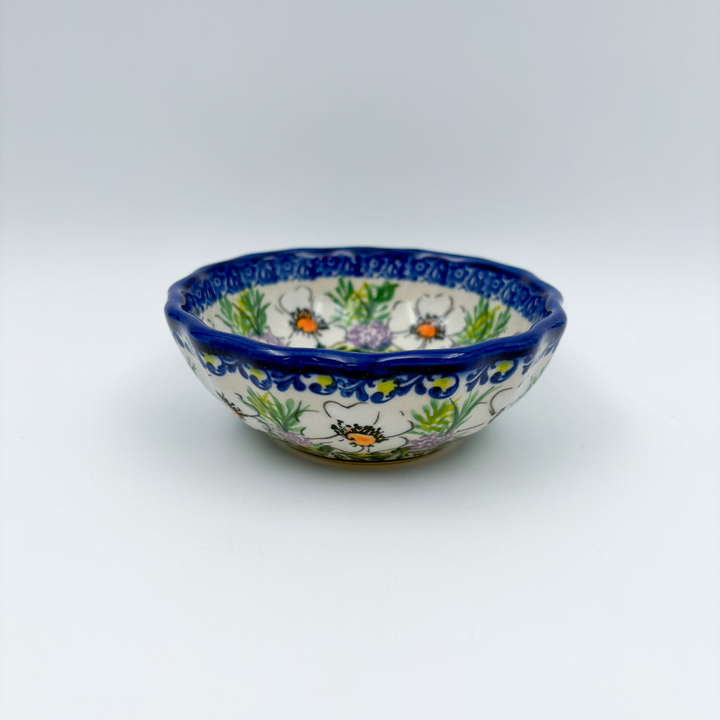 UNIKAT Primrose scalloped bowl, front view showing white poppies and lavender florals on scalloped rim