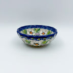 UNIKAT Primrose scalloped bowl, front view showing white poppies and lavender florals on scalloped rim