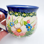 Pink Ruffle bubble mug held in hand, close-up front view