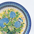 UNIKAT Blue Hydrangea plate, close-up rim view of blue hydrangea blooms and white butterfly
