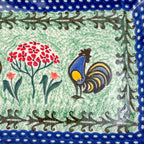 UNIKAT Rooster Dance rectangular platter, close-up of rooster and pom-pom flower with fern-scroll border