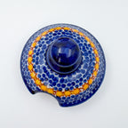Iza sugar bowl lid, Mushroom Design, top-down view of blue dotted knob and yellow star border