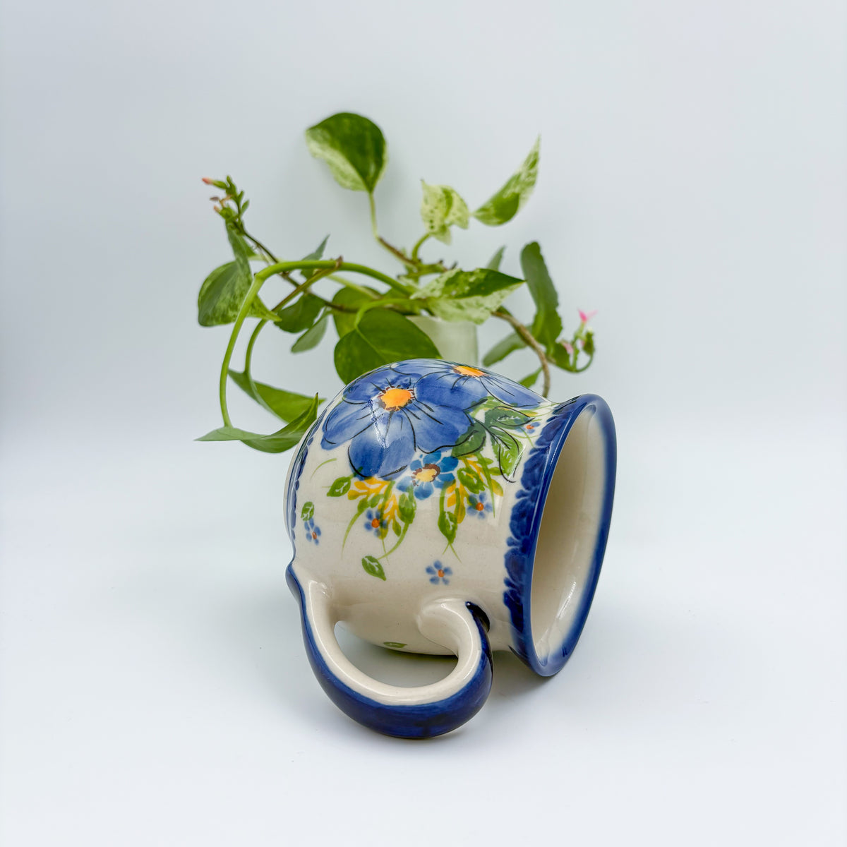Blue Pansy bubble mug tipped on its side showing interior rim and handle
