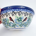 Gracious Gonolek stacking bowl held in hand, side view showing exterior pattern