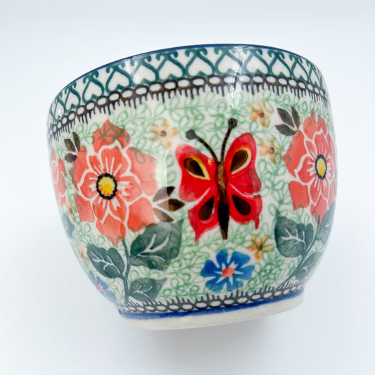 Polish pottery 16oz floral bowl with loop handle in the UNIKAT Sweet Leilani pattern. This Polish Pottery bowl is made by talented artisans from Poland.  16 oz of fluid.
6.26" x 4.49" x 5.51"
Ceramika Artystyczna Company
