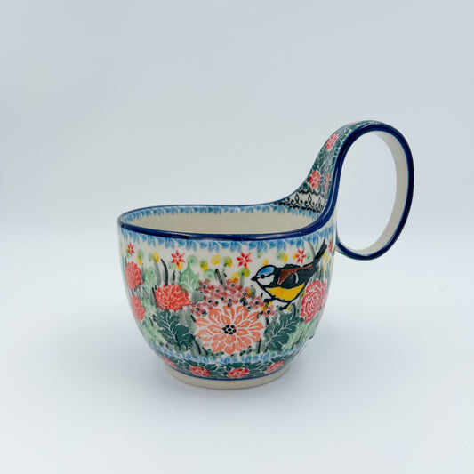 Polish pottery 16oz bowl with loop handle in the UNIKAT Robbin's Meadow pattern. 16 ounces of fluid.
6.26" x 4.49" x 5.51"
Ceramika Artystyczna Company