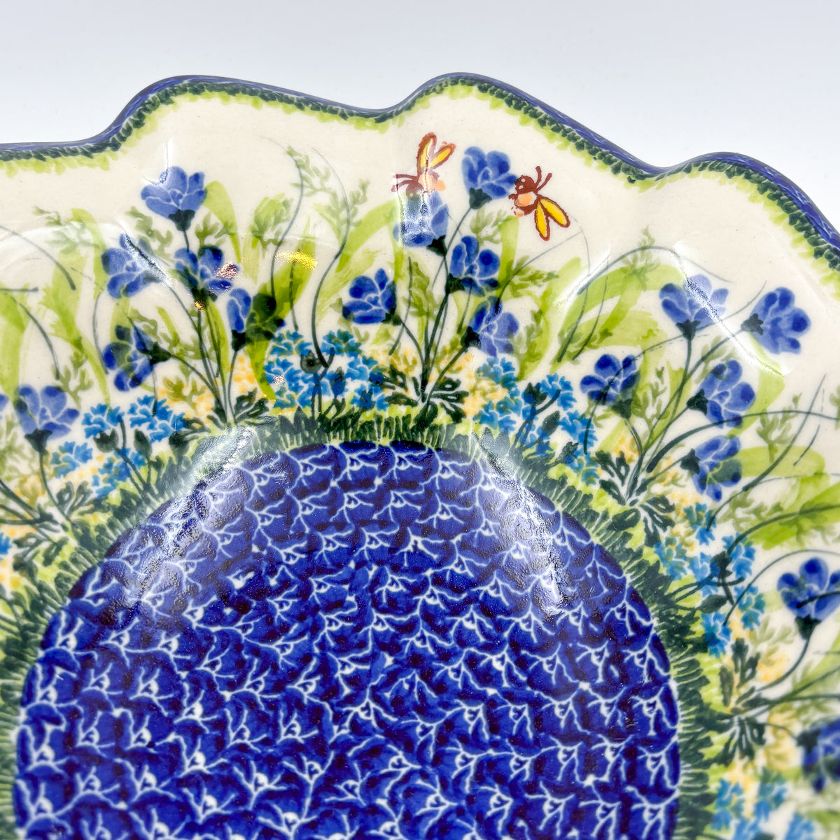 Close-up of scalloped rim showing dragonfly and bee on Bluebell Meadow wave bowl