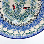 Close-up of bullfinch birds on rim of Gracious Gonolek stacking bowl