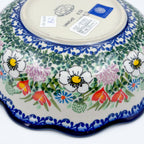 Angled view of Cottage Garden Kora bowl showing bottom stamp and exterior floral border