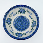 Blue Poppies stacking bowl on white background, top-down straight-on view