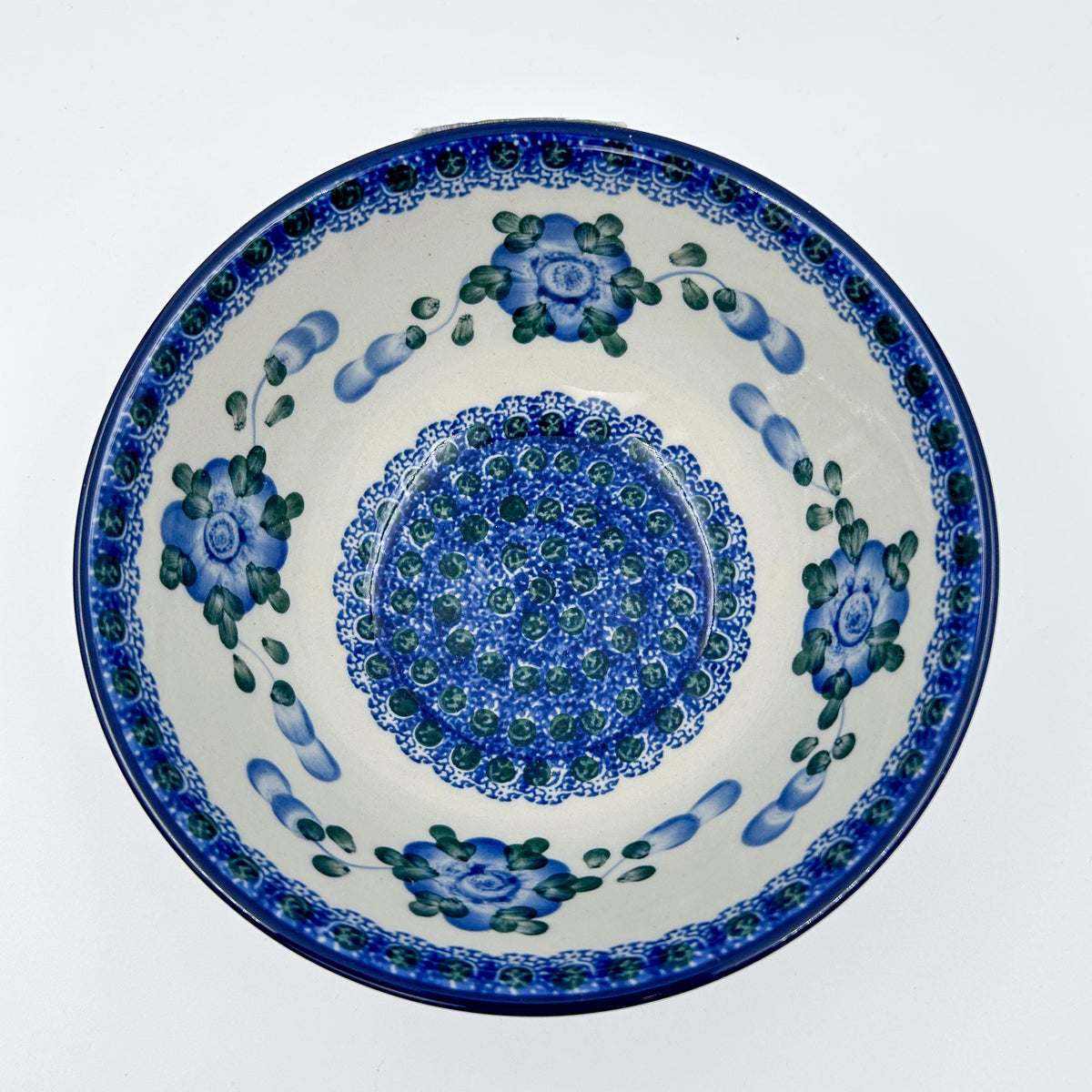Blue Poppies stacking bowl on white background, top-down straight-on view