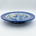 UNIKAT Blue Wildflower Patch pasta bowl, front view showing wide blue floral rim and wildflower center