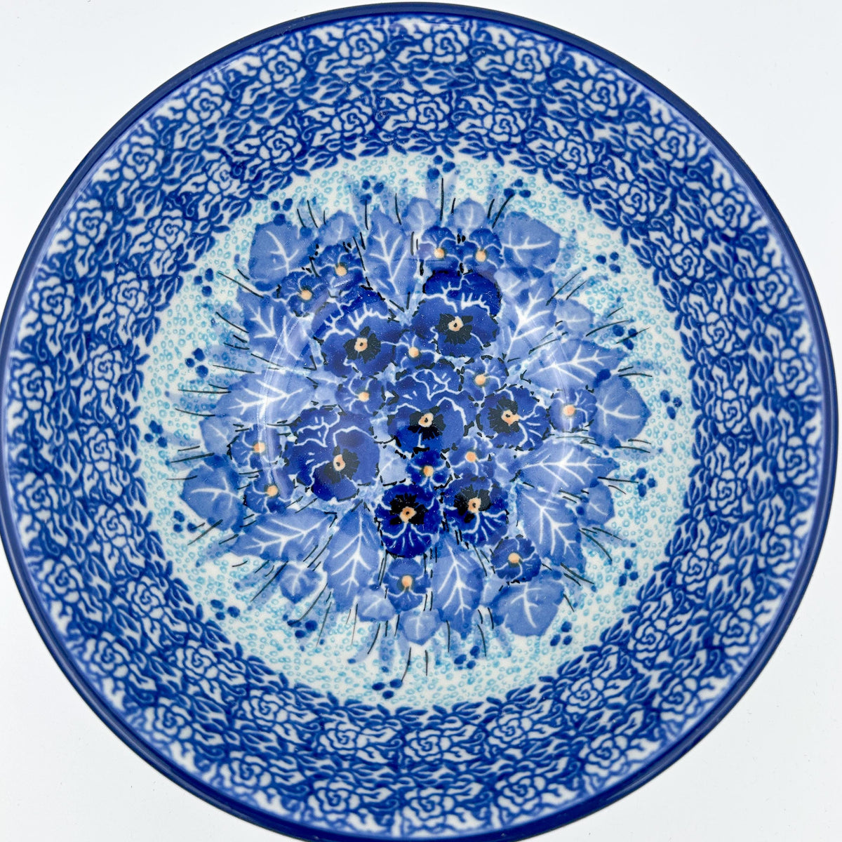 Deep Winter stacking bowl, top-down view showing pansy medallion center