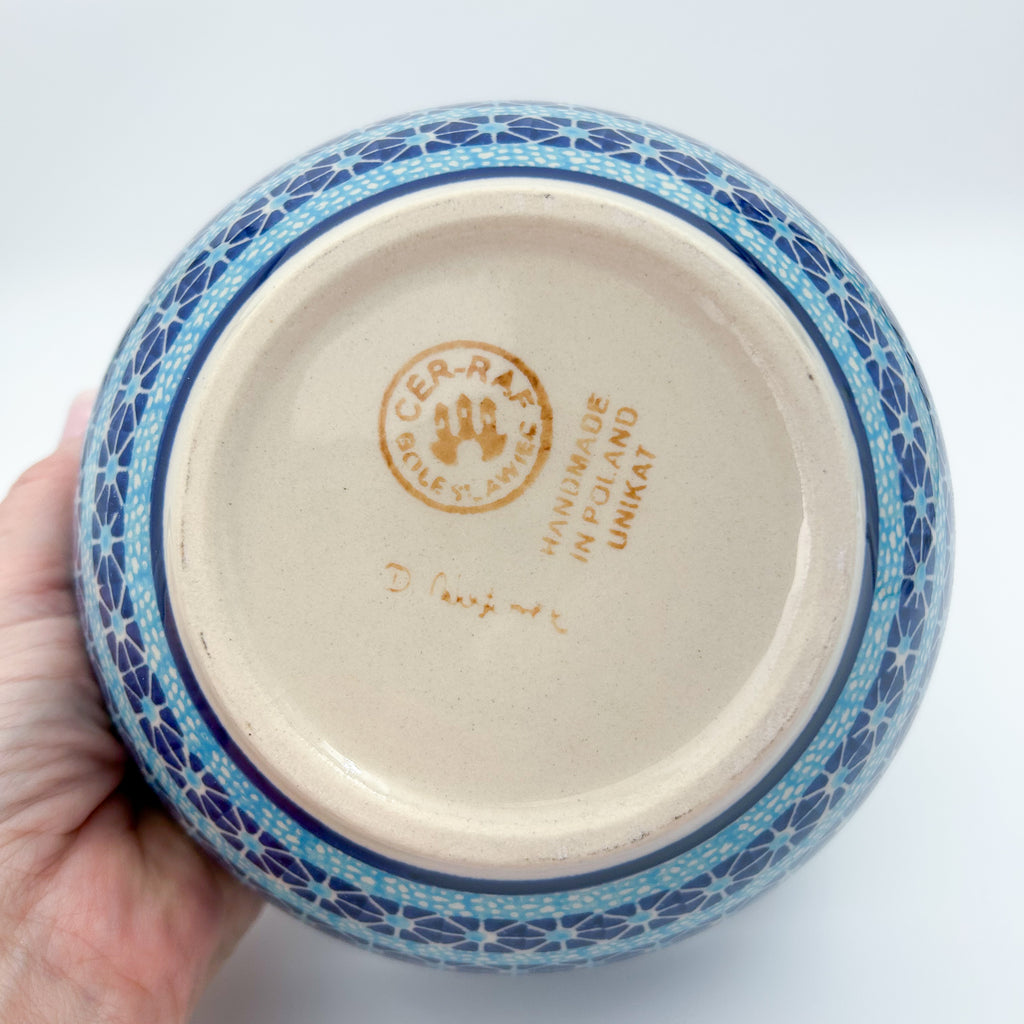 Bottom of Corn in the Blue deep bowl showing Unikat stamp, held in hand