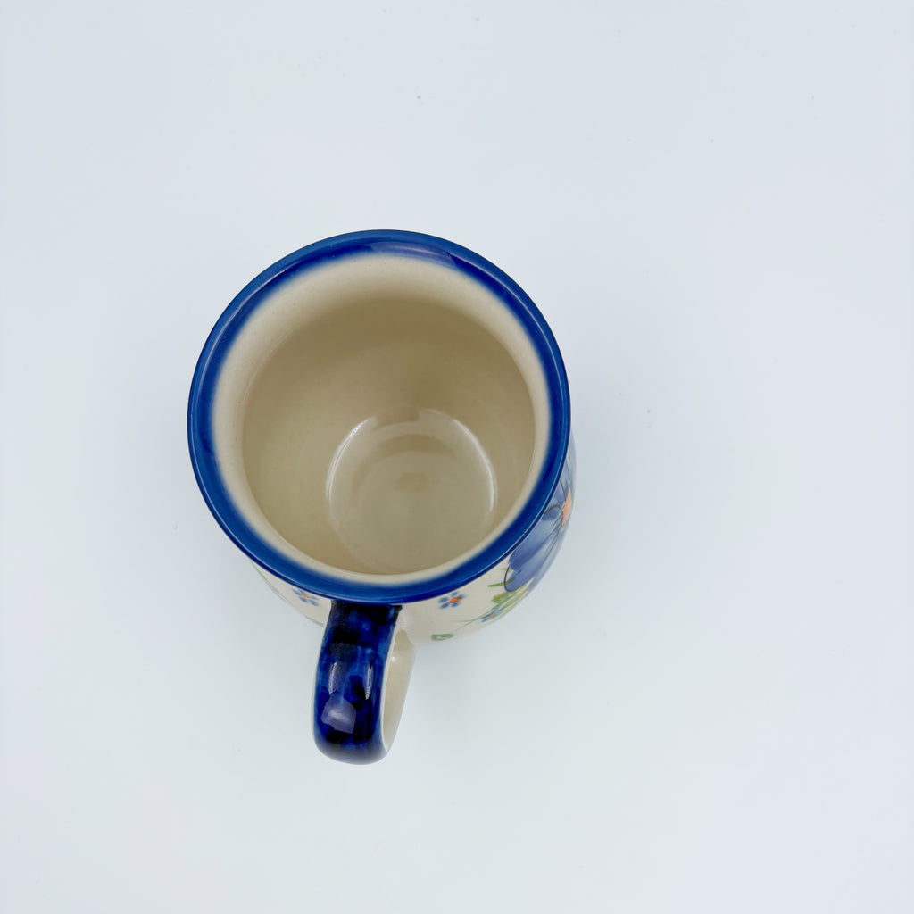Top-down view into Blue Pansy bubble mug showing cream interior and blue rim