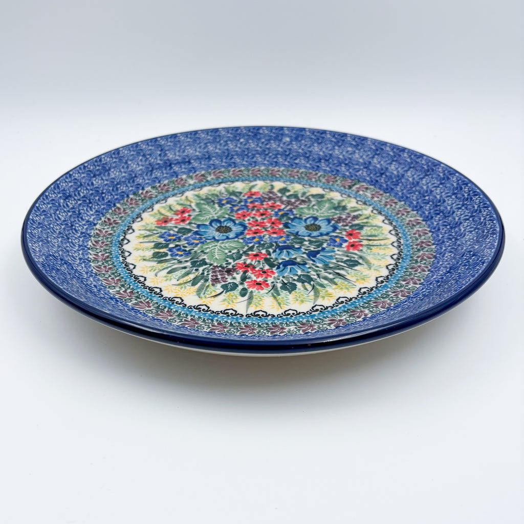 UNIKAT Splendid Meadow plate, front view showing red and blue floral bouquet and mosaic border