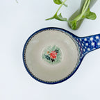 Polish pottery 16oz floral bowl with loop handle in the UNIKAT Sweet Leilani pattern. This Polish Pottery bowl is made by talented artisans from Poland.  16 oz of fluid.
6.26" x 4.49" x 5.51"
Ceramika Artystyczna Company