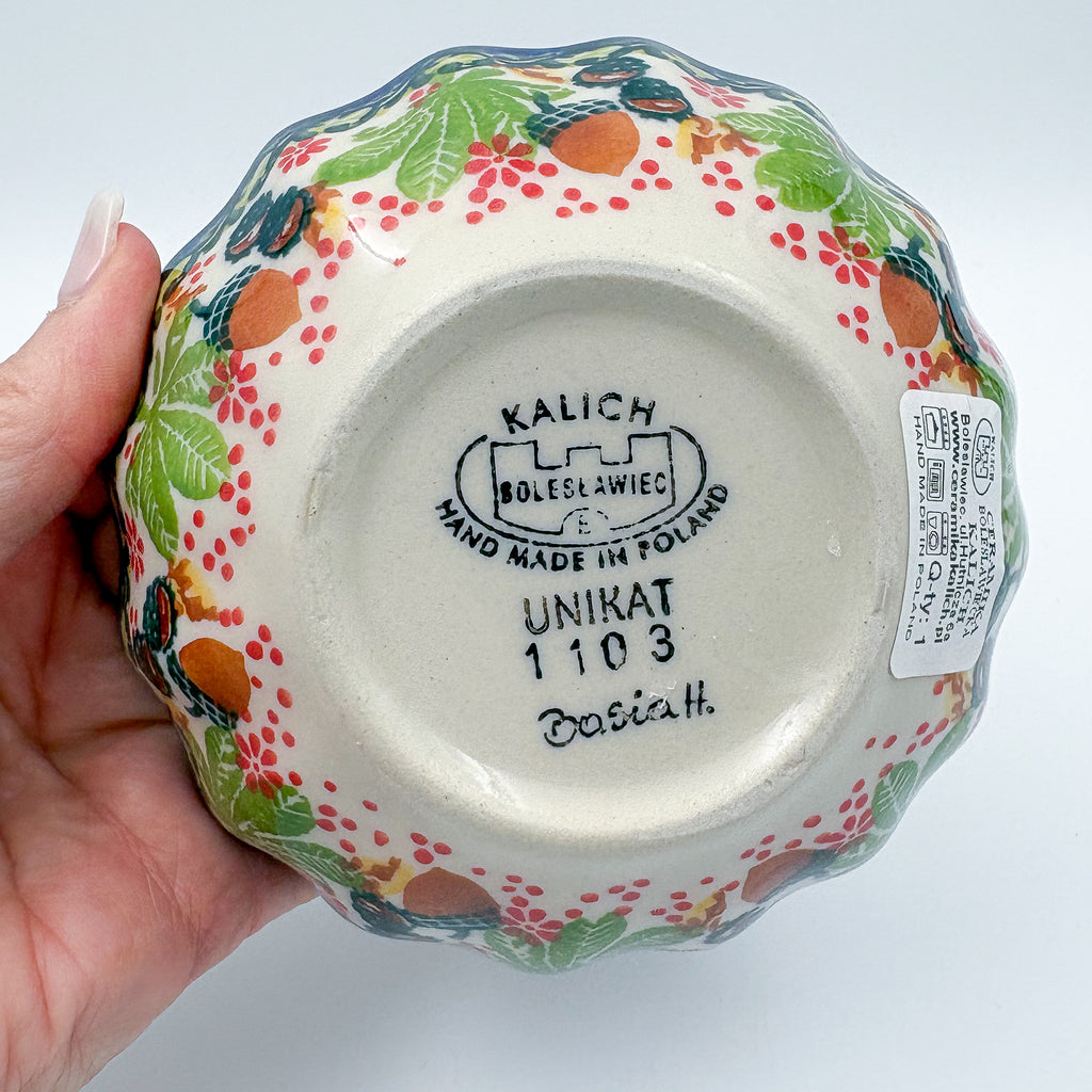 UNIKAT Hedgehog and Pumpkin scalloped bowl, bottom stamp with Kalich Boleslawiec Unikat mark held in hand