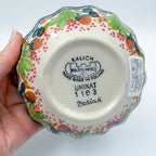 UNIKAT Hedgehog and Pumpkin scalloped bowl, bottom stamp with Kalich Boleslawiec Unikat mark held in hand