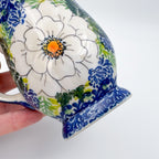 Close-up of painted rose bloom on Wild Rose tulip mug, held in hand