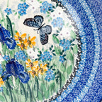 UNIKAT Sweet Nectar plate, close-up view of blue butterfly among iris and yellow flowers