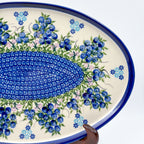 UNIKAT Blueberry oval tray, angled view of mosaic center band and blueberry clusters displayed on stand