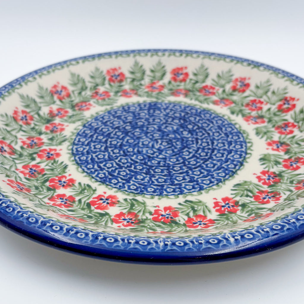 Midsummer Bloom plate, close-up angled view of red flower ring and blue mosaic center