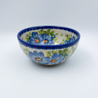Blue Daisy bowl, front view showing large blue daisy flowers on cream background