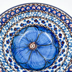 UNIKAT Cobalt Poppies bowl, close-up exterior view of peacock feather scale pattern near bottom stamp