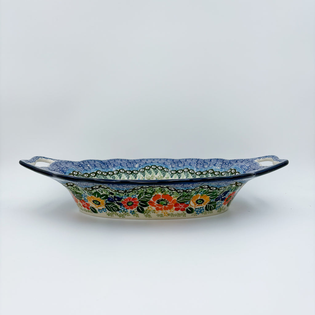 Iris Meadow oval platter with handles, straight-on side view showing cutout handles and exterior floral band